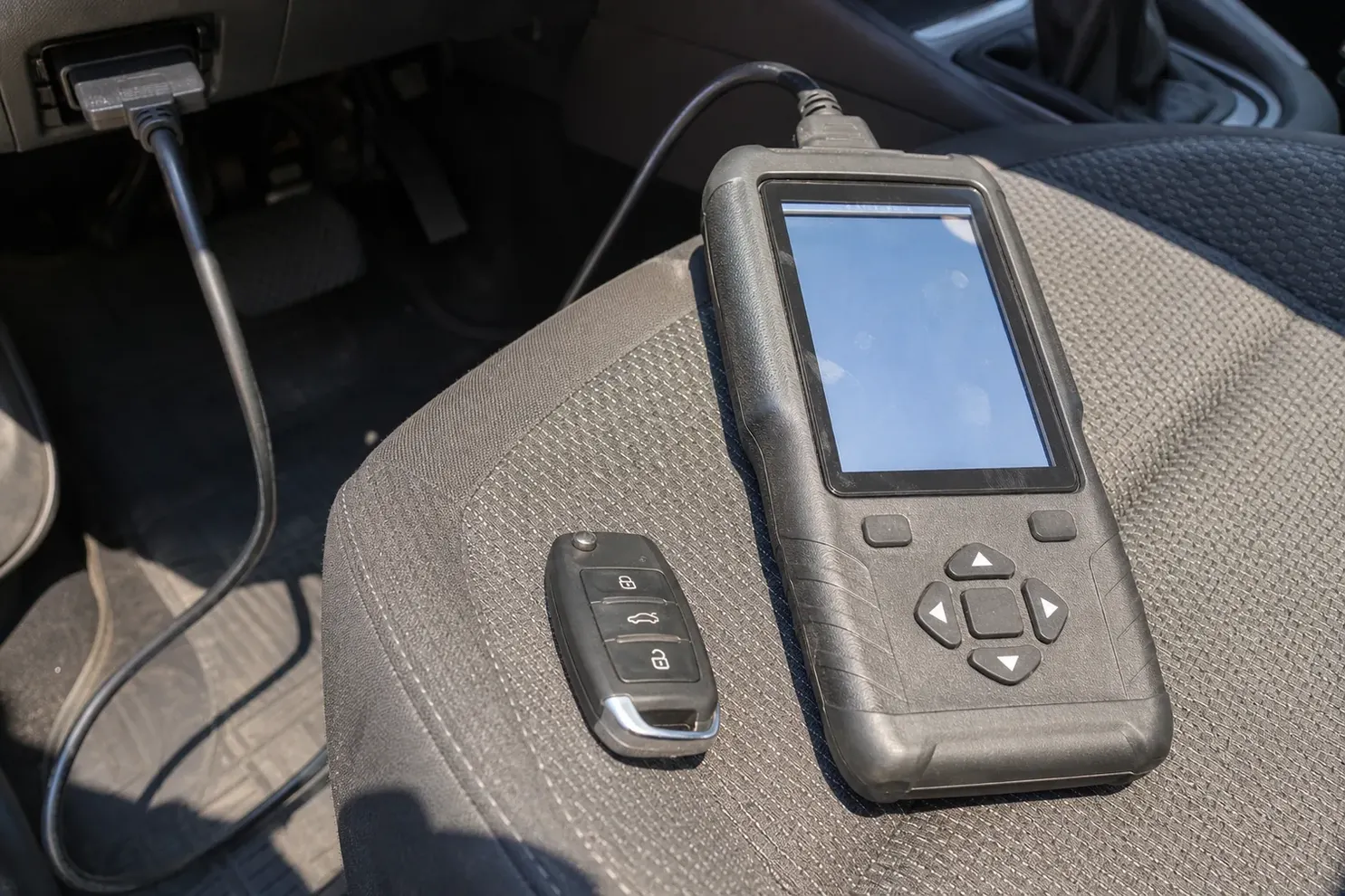 Car key programmer plugged into the OBD port in Toms River, NJ